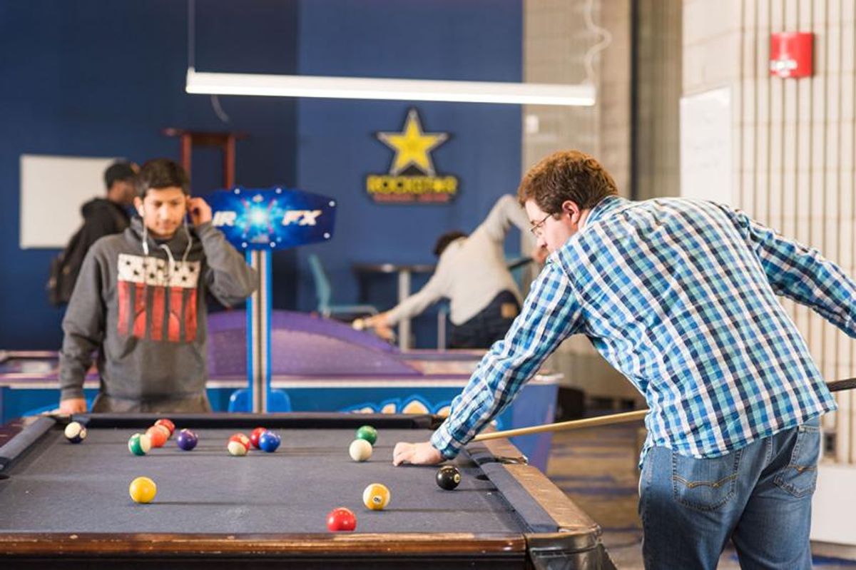 Students shooting pool in the Campus Center's game room. 