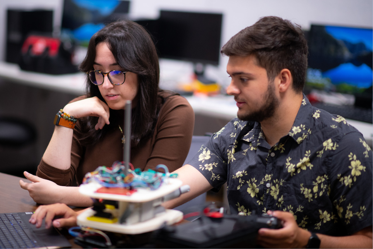 Photo of computer science grads Cameron McAlpine and Erika Caushi '23