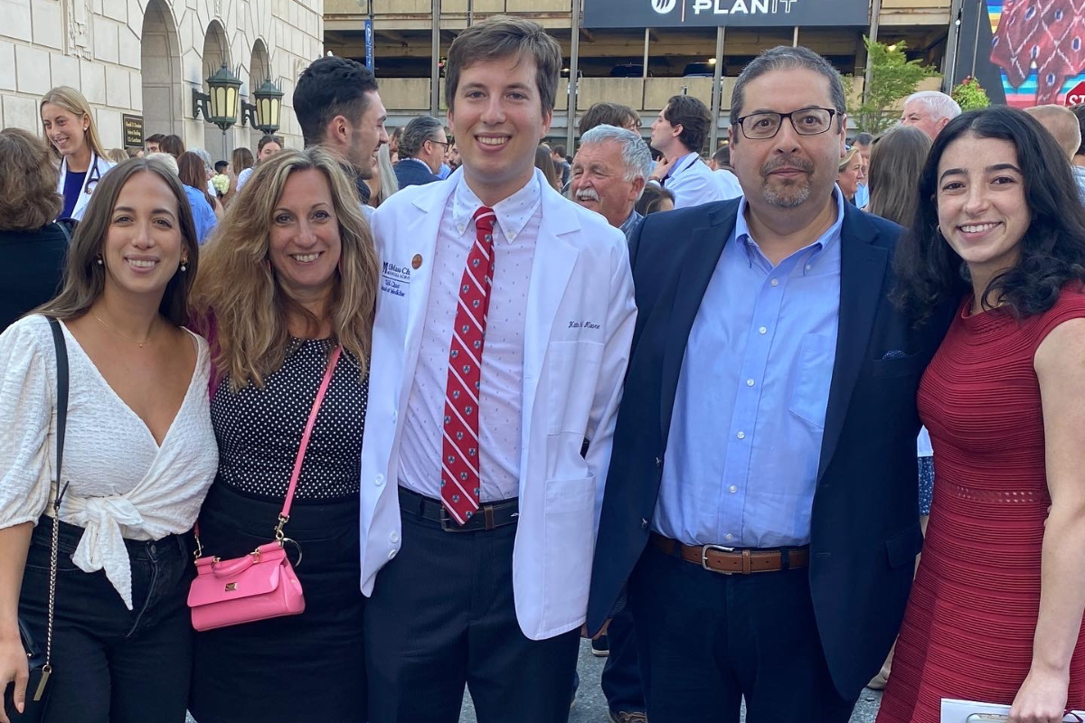 Alum & family at white coat ceremony