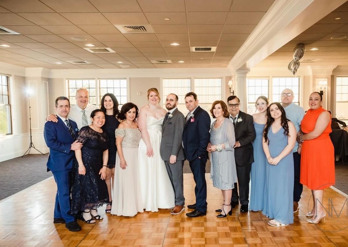 Torres poses with her family at a wedding
