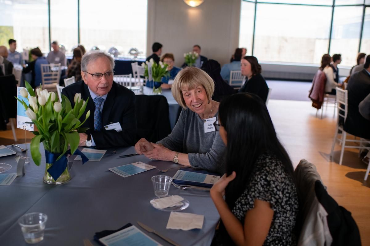Donors speak with student at Scholar Day