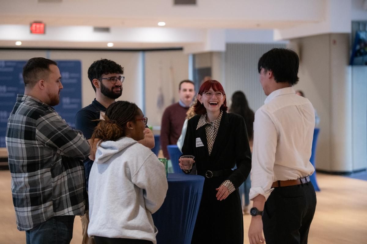 Students laughing with alumni
