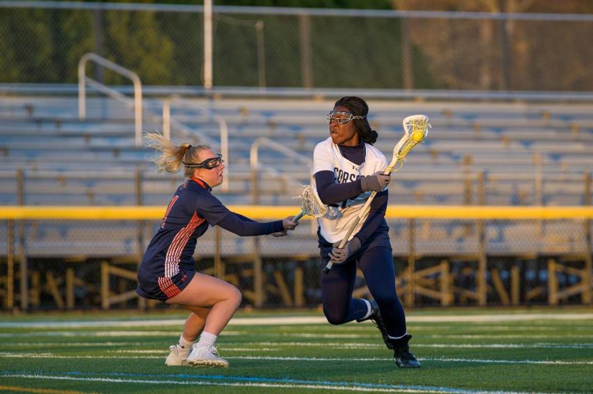 Widline Thomas dodges past a Western Connecticut defender