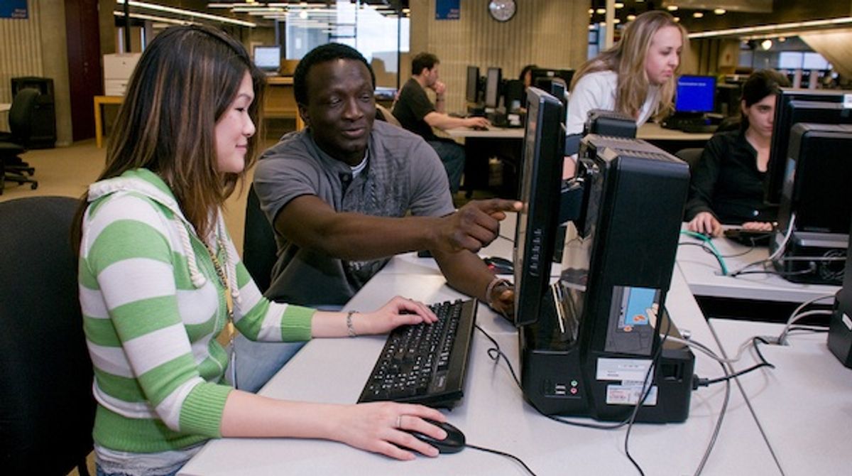 CITS helping student in computer lab