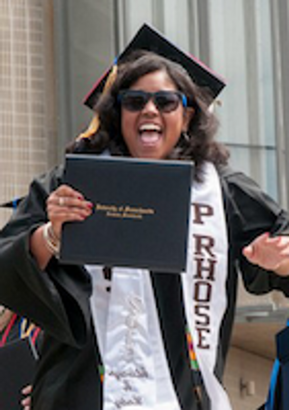 CJS alumna ashley in her cap and gown