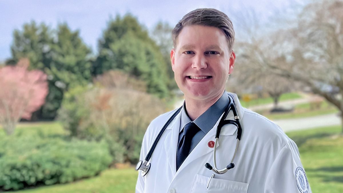 Standing on lawn in lab coat with stethoscope
