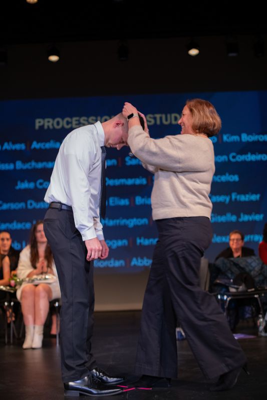 ABSN graduate being pinned at ceremony