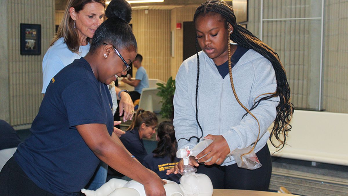 Students practicing CPR with Dean Barnett