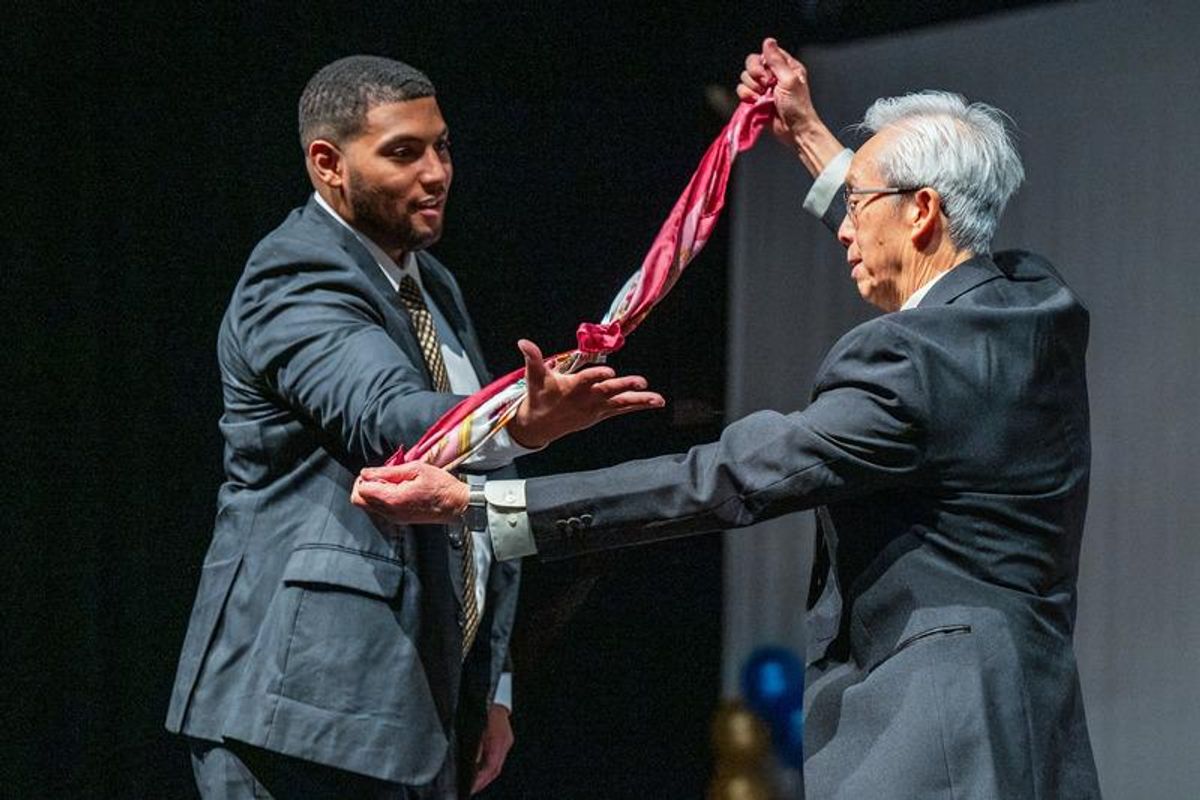Professor TSu doing magic tricks with Daishawn Barros