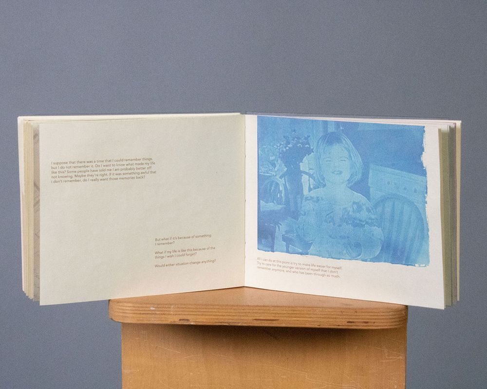 [REDACTED] Cyanotype Details, 2022, a spread from The Internal Debate – showing a cyanotype of Gwen as a baby, 15x6 in