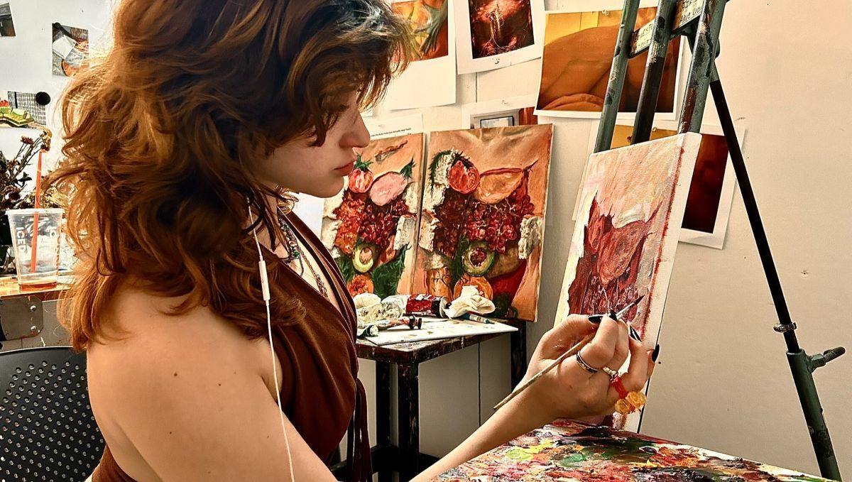 Isabella Carinci painting on an easel in studio