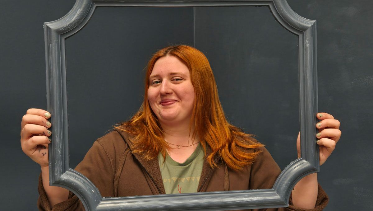 Jillian holding frame in gallery