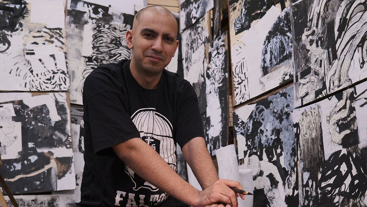 Ali Masoumzadeh in studio with artwork