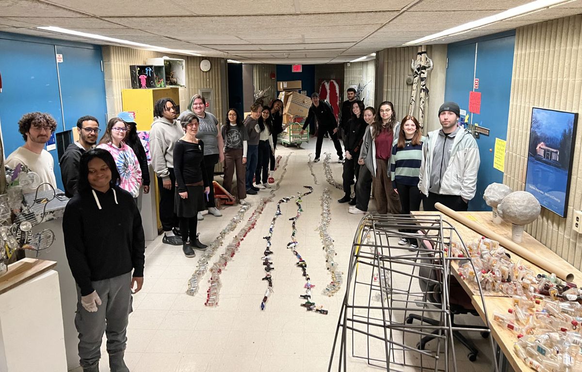 Students from Rachel Kulick's sustainable cities class drill and string bottles