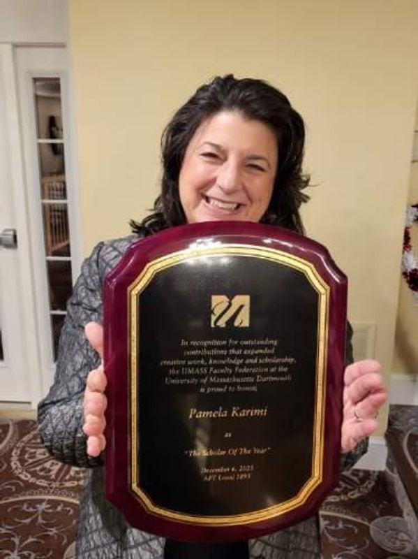 Associate Professor of Interior Architecture + Design accepts Pamela Karimi's award in person.