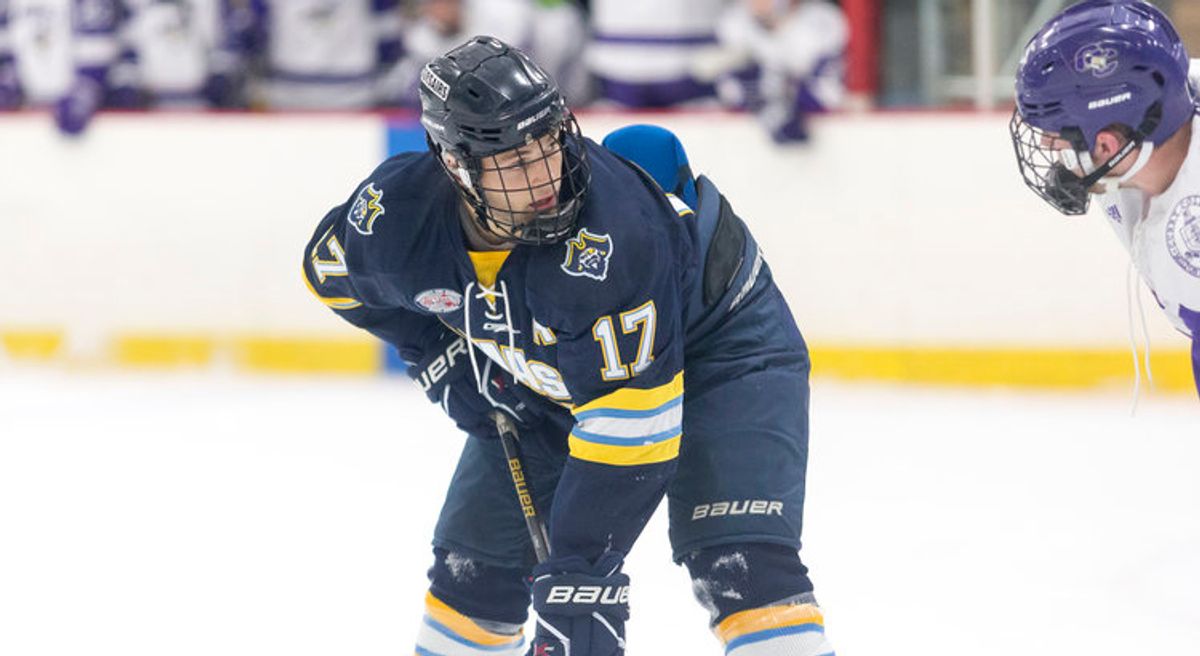Student playing hockey
