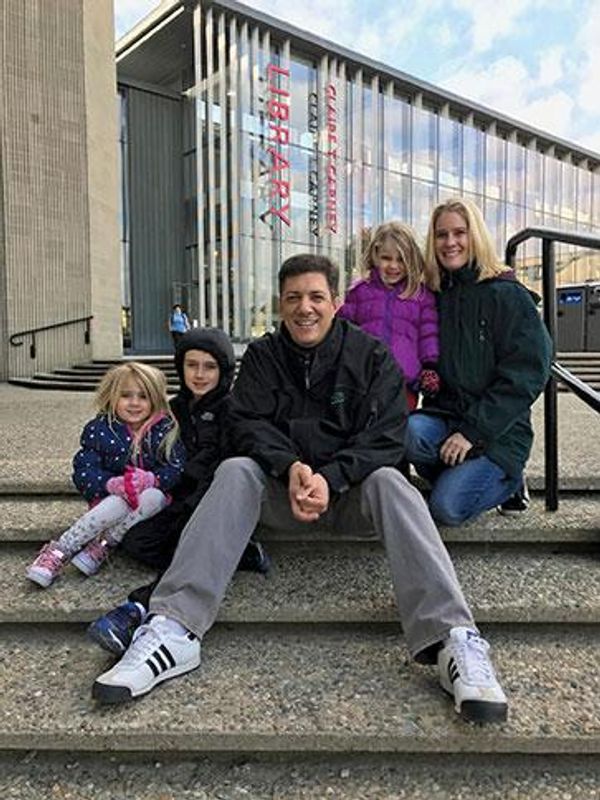 Roxanne Leone '94, right, and husband Michael Leone '94, and their children - on the  campus