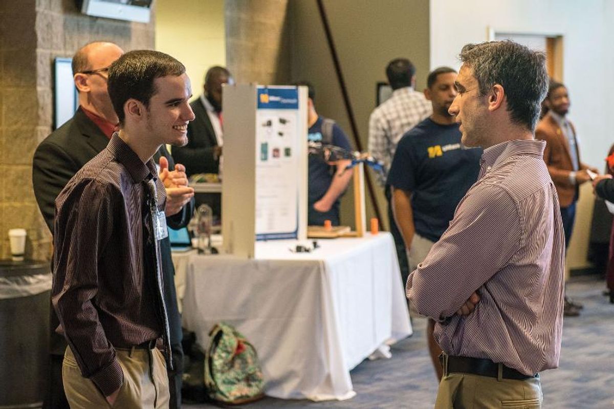 Dr. Lance Fiondella, right, and student - College of Engineering senior design capstone project in May of this year.