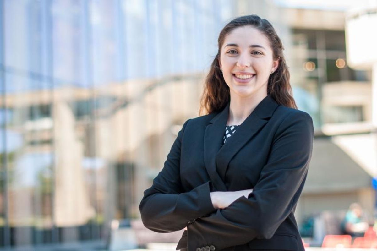 Mechanical engineering major Megan Scribner '19 standing in front of the library