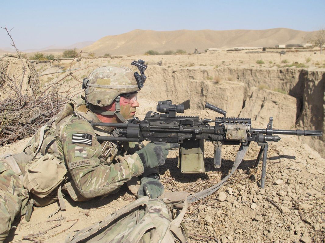 Ed Collins '19 on patrol in Afghanistan wearing Army fatigues in the desert