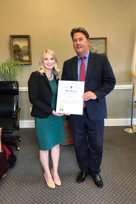 Senator Montigny presenting Kayla Venckauskas with an official citation