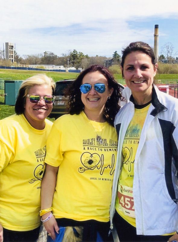 Keryann Estrela surrounded by close friend Kim Carvalho (left) and Assistant Dean of the College of Nursing & Health Sciences (right)