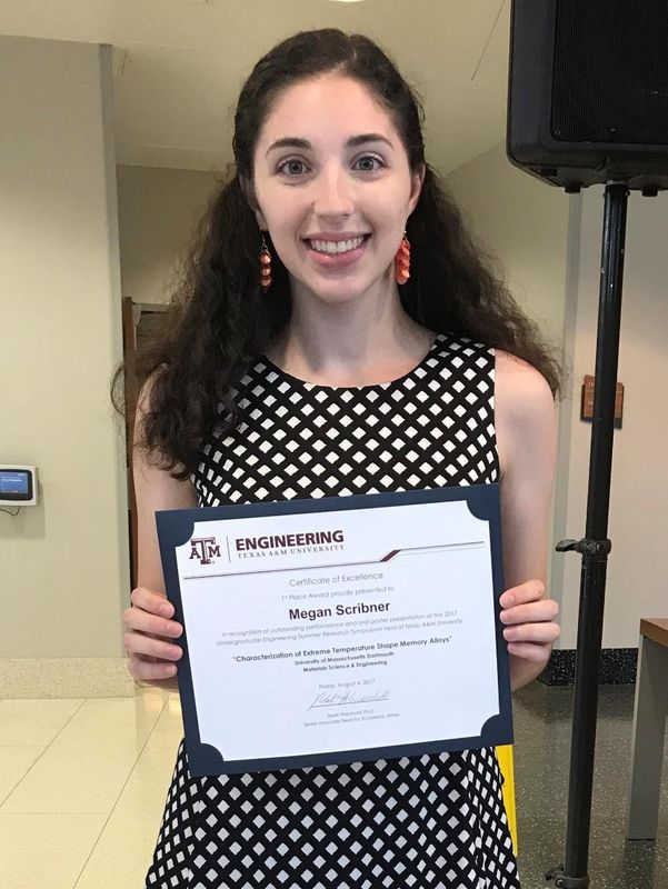 Megan Scribner '19 holding her research award from Texas A & M University