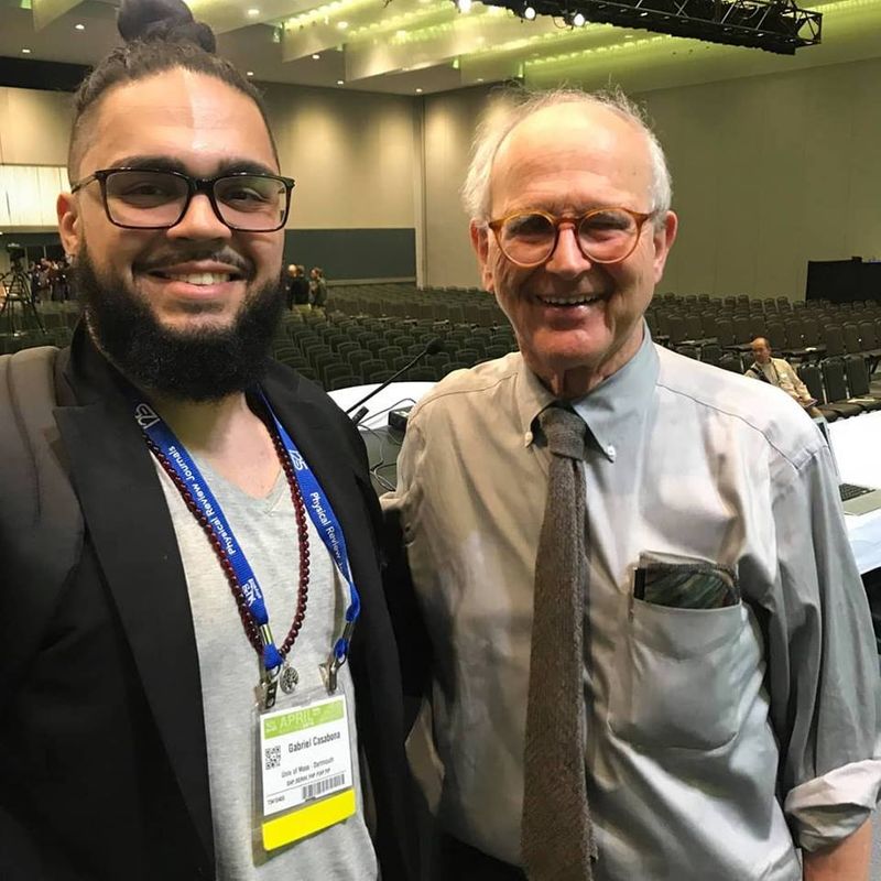 Gabriel Casabona (MS/Physics) standing with Dr. Robert Weiss, professor emeritus of physics at MIT and winner of the 2017 Nobel Peace Prize.