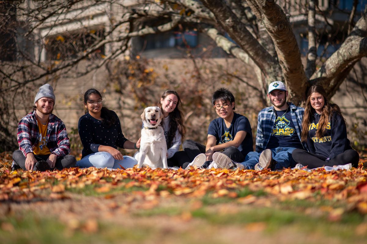 Gracie with students outdoors