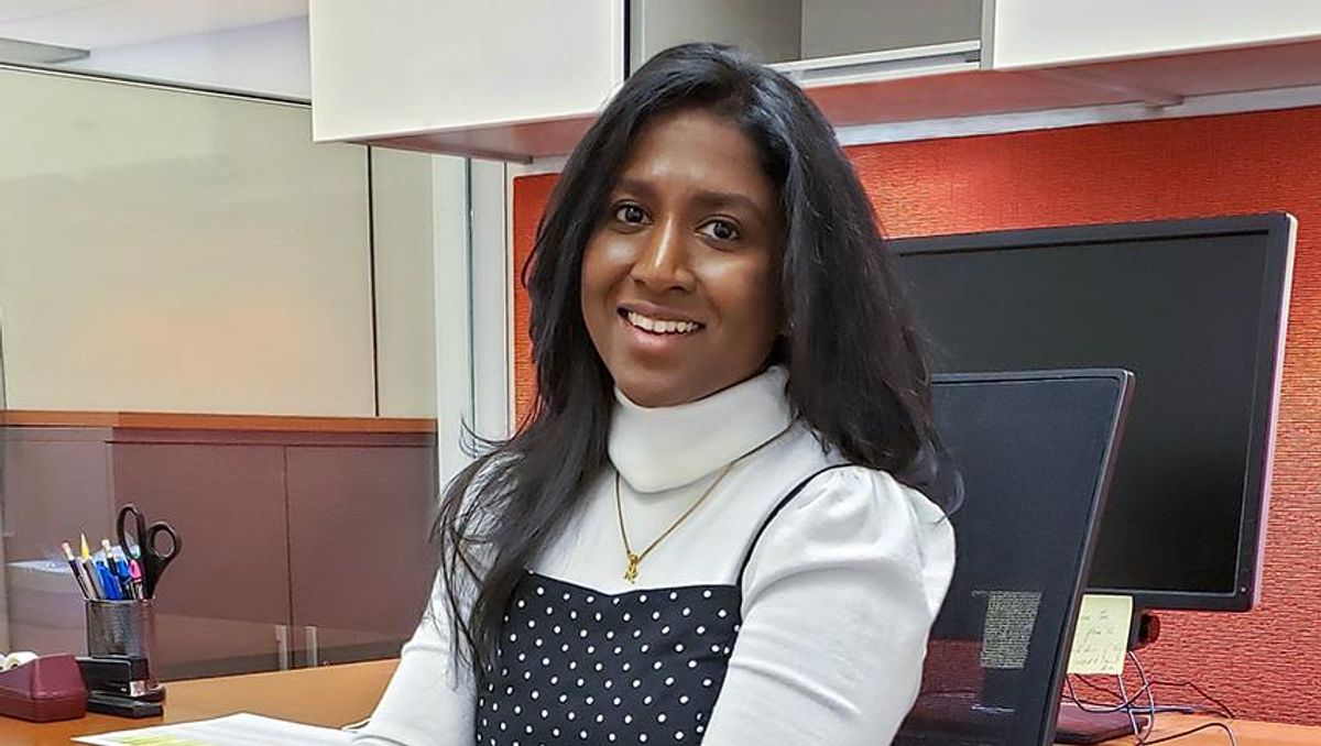 graduate student teacher Merin Bosco seated at her desk