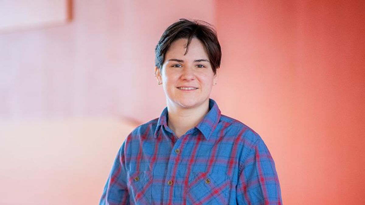 student lucy mcginnis against red and orange wall