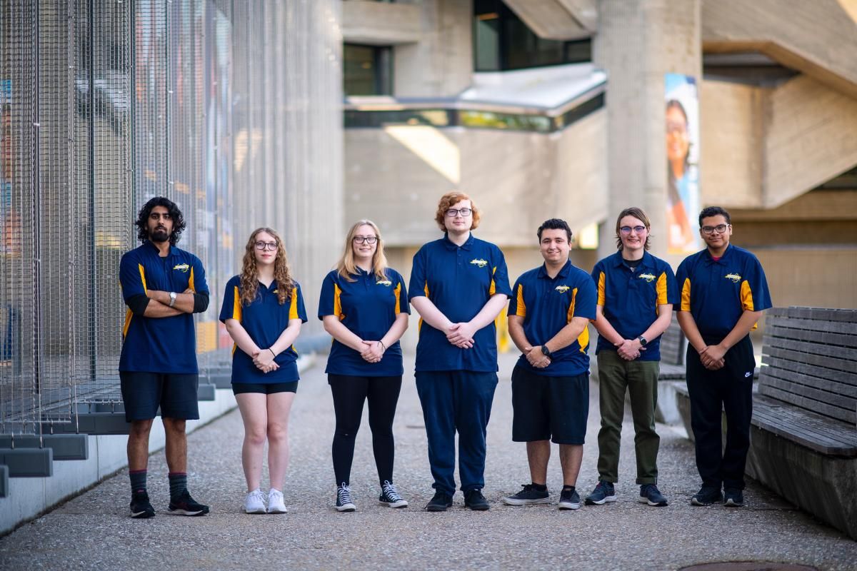 Students in the Engineering Ambassadors group standing in a row outside the library