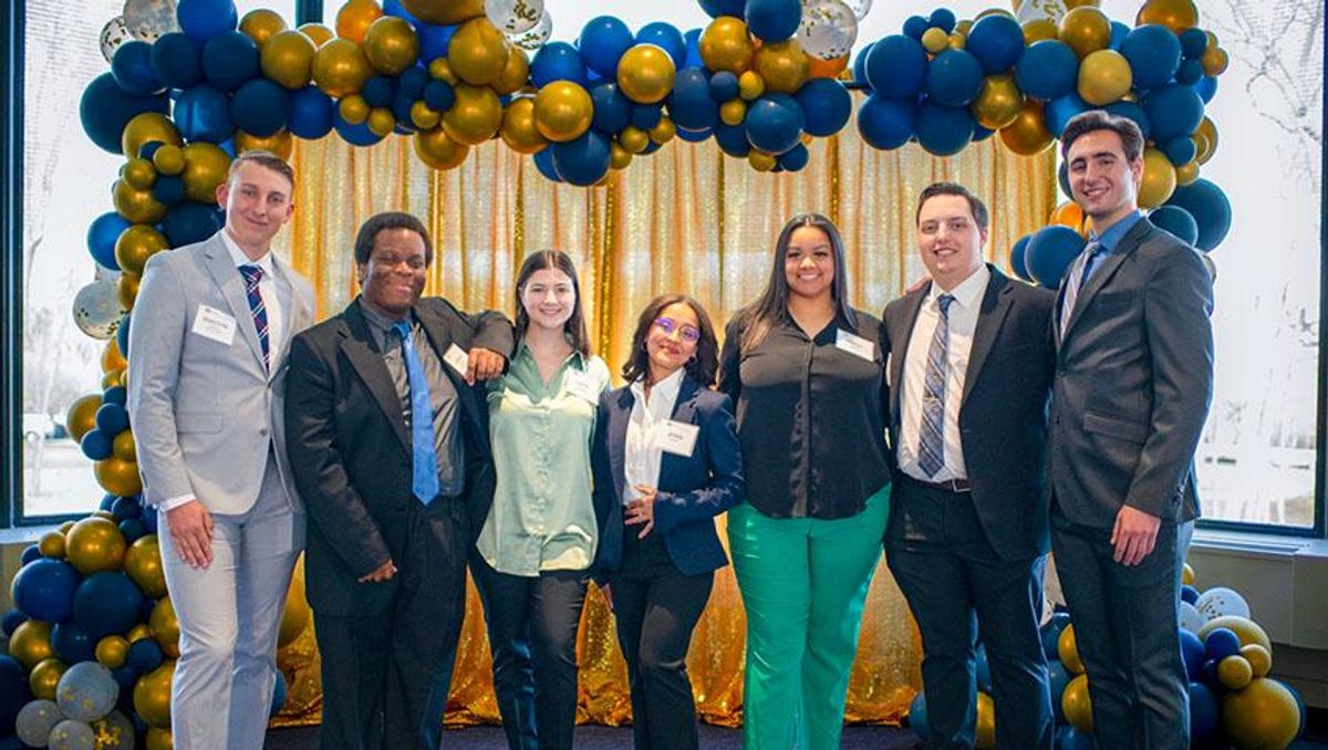 Capri McLucas pictured with fellow students at the 2023 UMassD Alumni Awards.