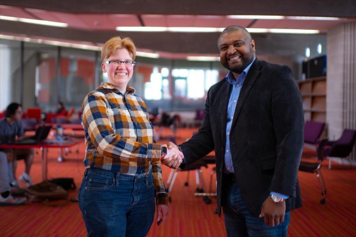 Civil Engineering student Melody Veldorale '23 shaking hands with La Var Williams of the Volpe Center
