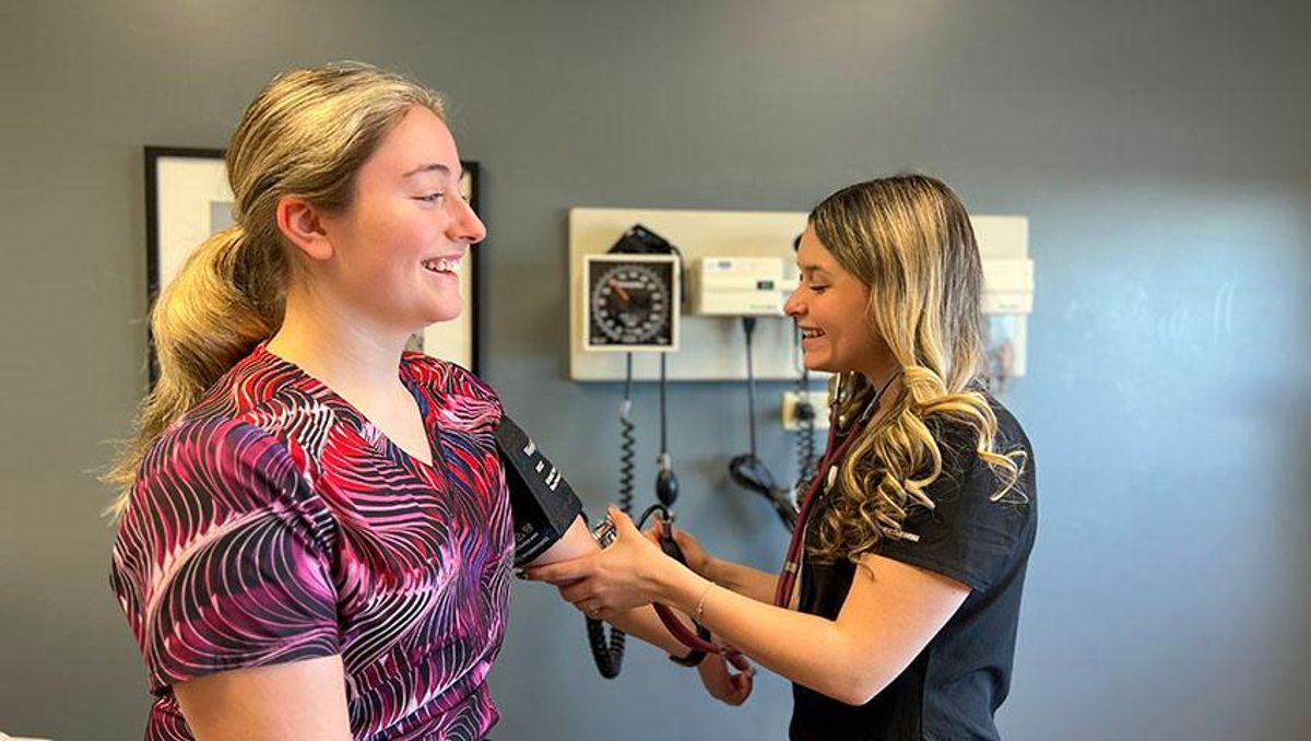 Chelsee Teotonio '26 checks a patient's blood pressure at Hawthorn Medical Associates in Dartmouth, MA.