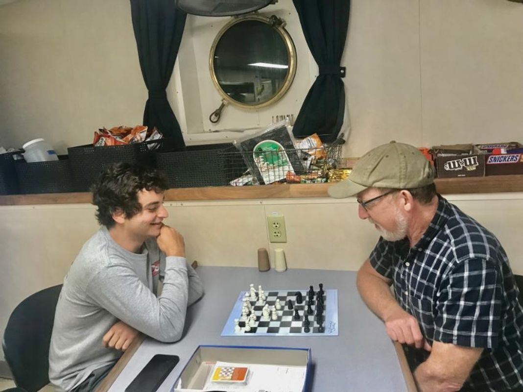 Juan and Prof. Mark Altabet playing chess on board the research vessel the Sally Ride