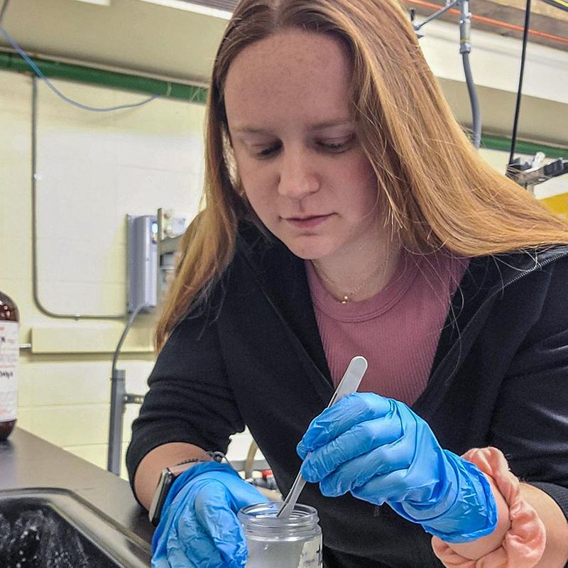 student christina hart conducting research in lab