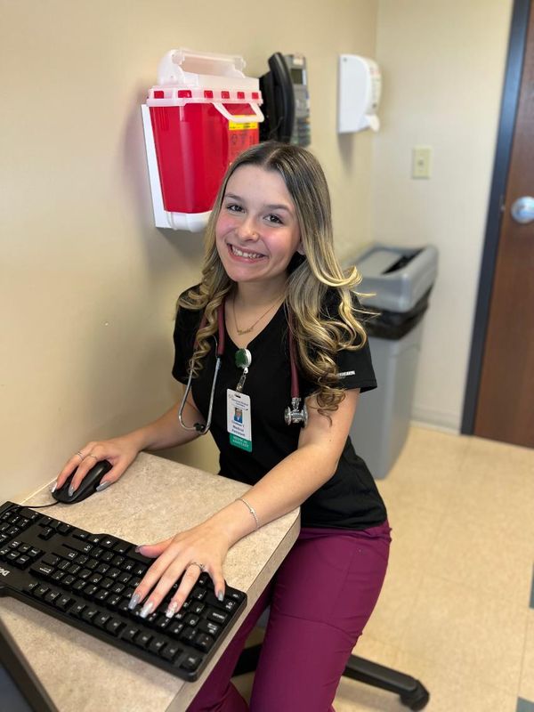 Chelsee Teotonio poses at her job at Hawthorn Medical Associates in Dartmouth, MA.