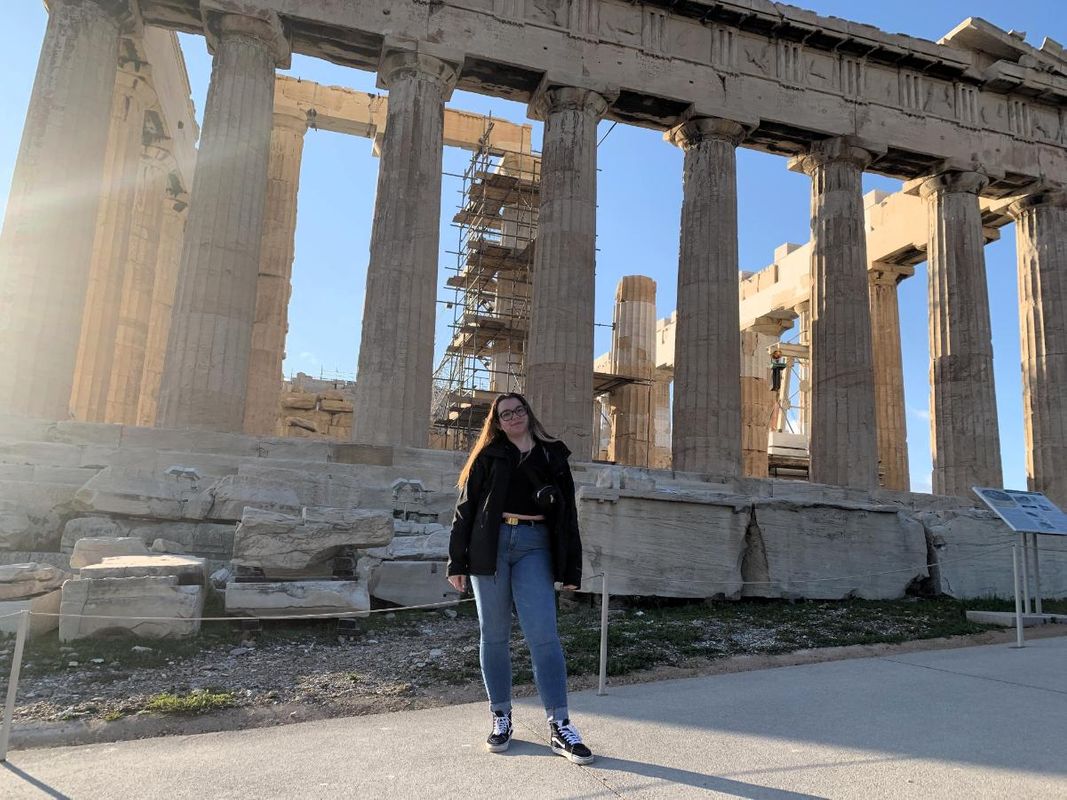 Unique Linnell standing in front of ancient ruins in Athens, Greece