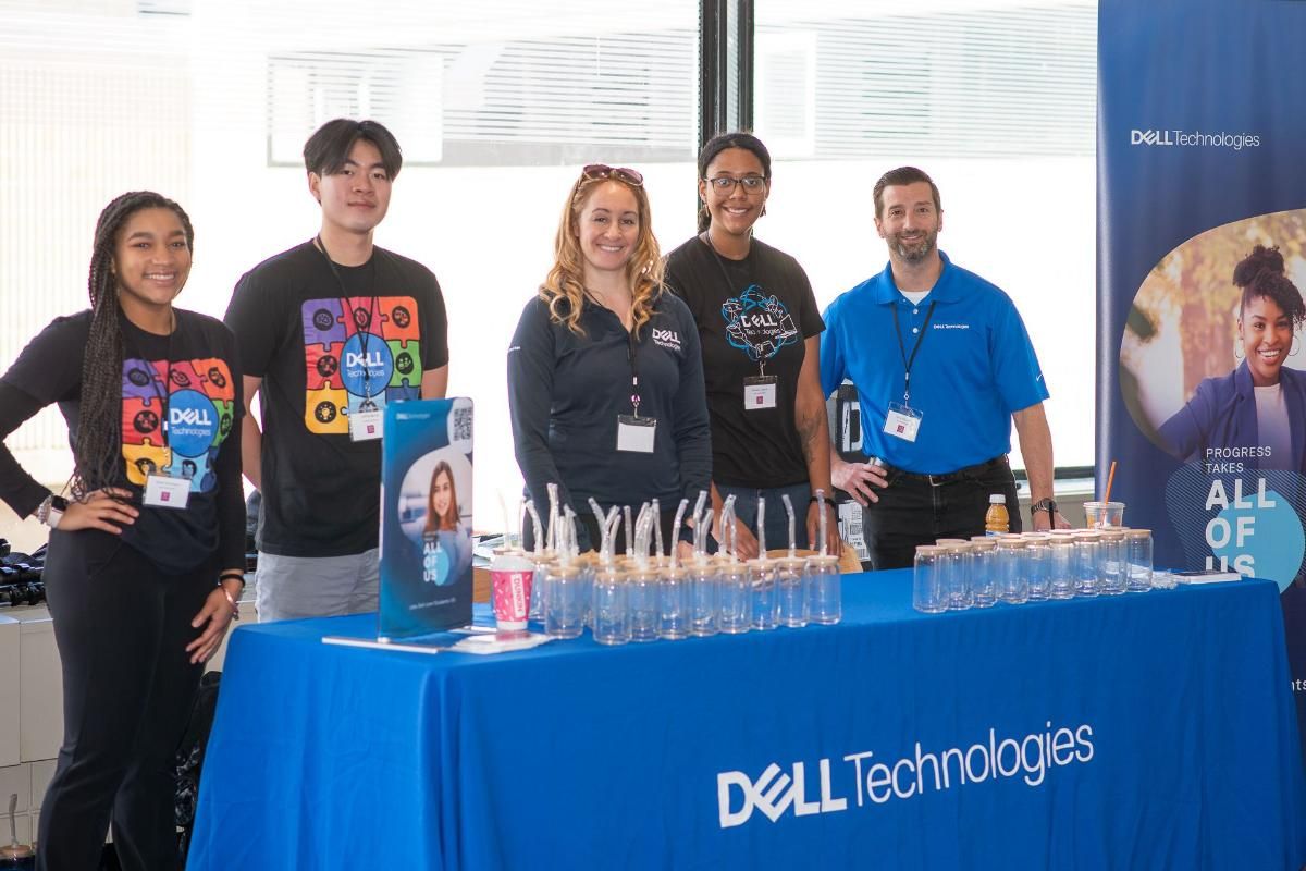 Dell employees gathered around a table at an event