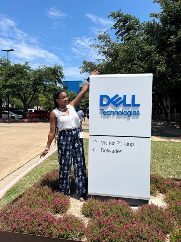 Ashlee Shuemaker standing in front of the Dell Technologies sign