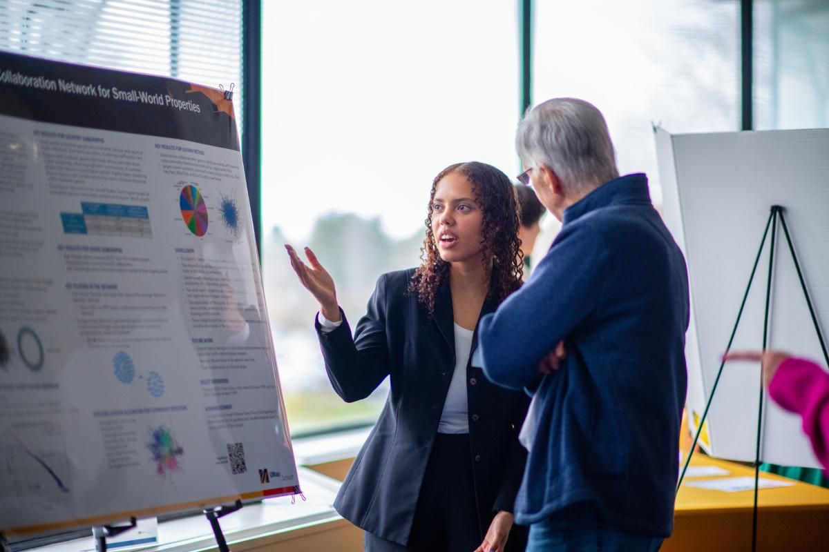 Computer science graduate student Raquel Bush presenting her work at Scholar Day