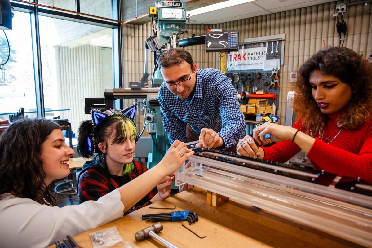 Mechanical engineering students Alexis Medeiros, Molly Henderson, and Anamika Menon in the lab with Professor Hamed Samandari