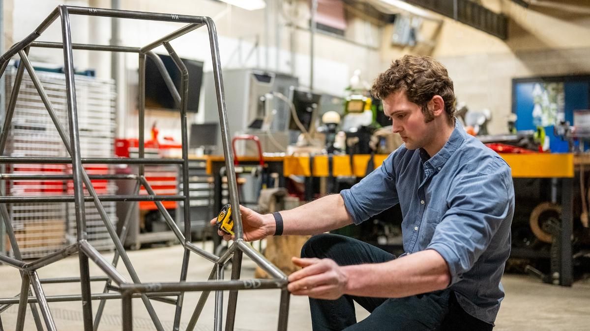 Mechanical Engineering major Ryan Masoud working on the Baja SAE vehicle