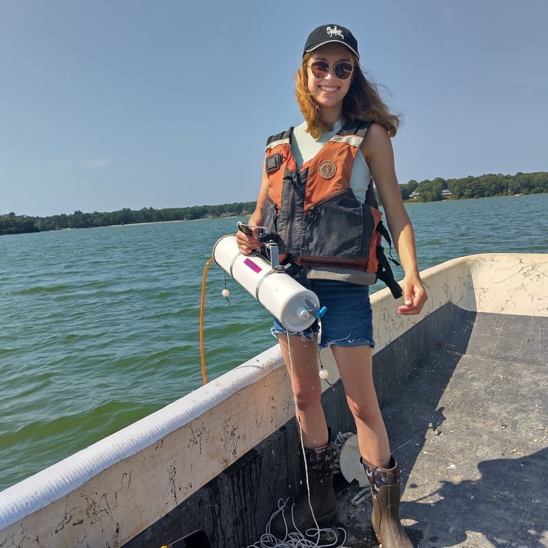 Mia Oliveira '26 conducting field research on a boat