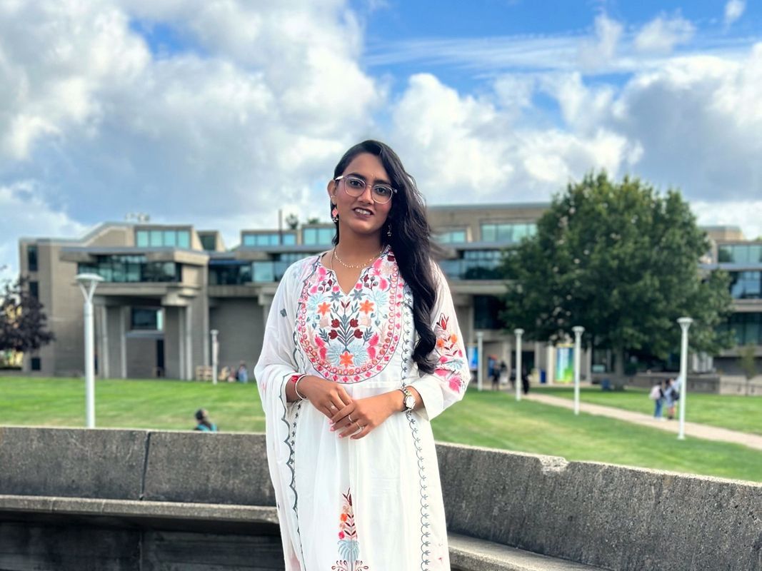 Bioengineering student Kavya Shah standing in front of the campus quad