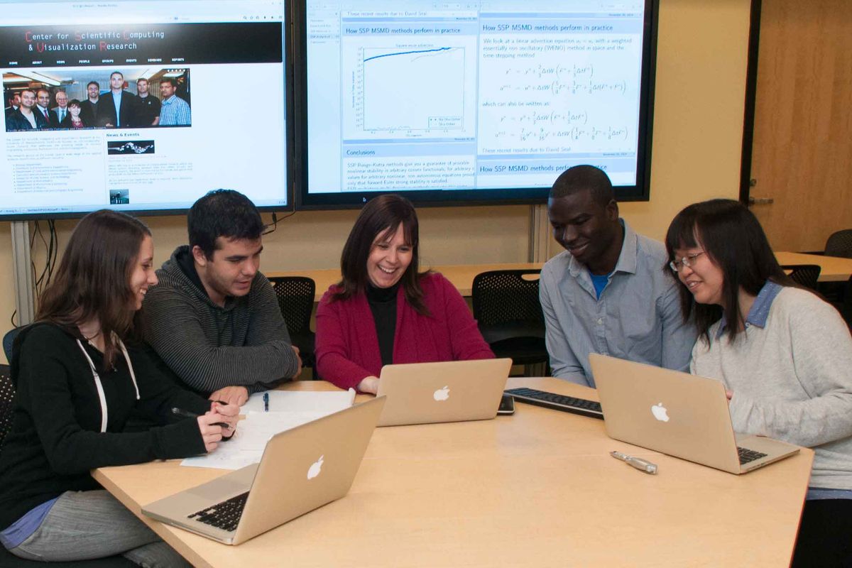 Sigal Gottlieb working with grad students at UMass Dartmouth's Center for Scientific Computing and Visualization Research (CSCVR).