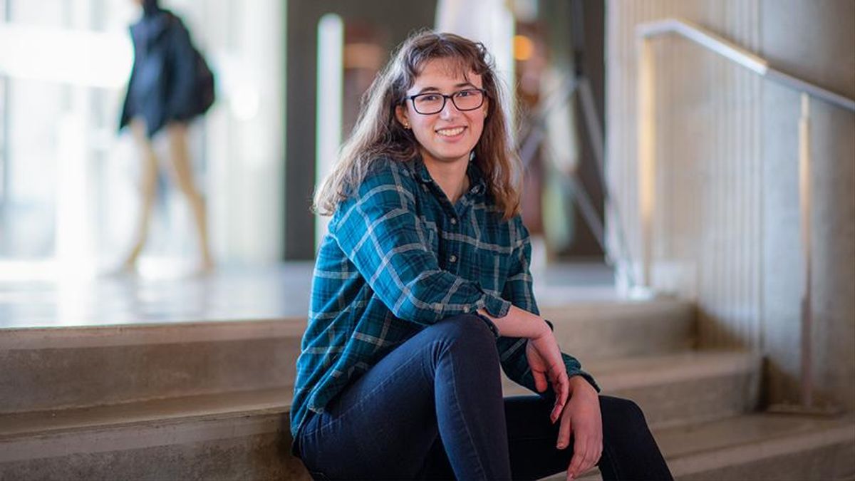 Student sitting on steps in Library