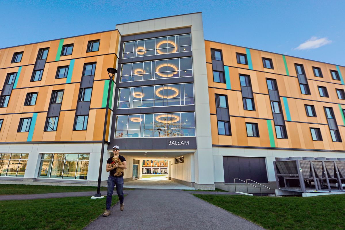 Student walking from Balsam Hall.