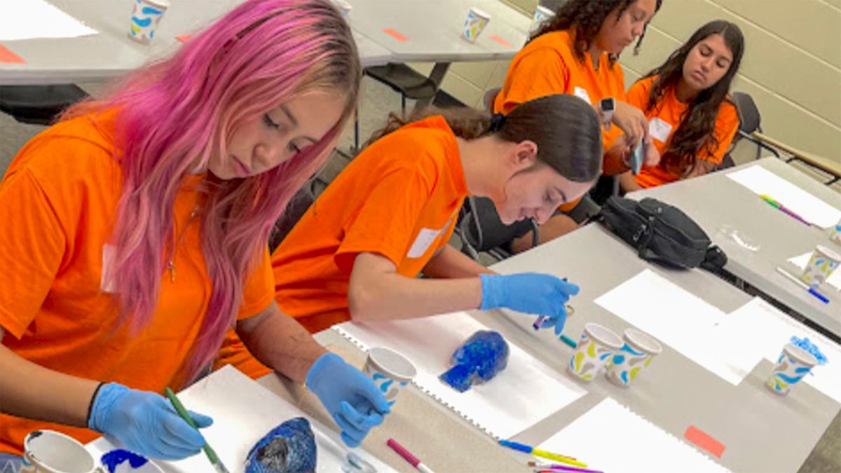 Students practicing Gyotaku, the Japanese art of fish printing, during an anatomy workshop with STEM4Girls